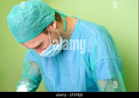 Male surgeon in operation room with protective workwear. High quality photo Stock Photo