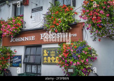 Dublin, Ireland, August 2019 Closeup on Johnnie Foxs sign. Pub and restaurant established in 1798 is one of the oldest and highest pubs. Stock Photo