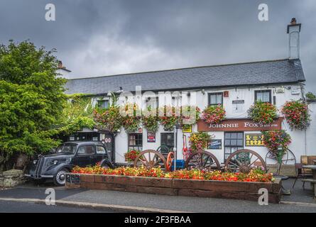 Dublin, Ireland, August 2019 Front view on Johnnie Foxs pub and restaurant established in 1798 is one of the oldest and highest pubs. Vintage car Stock Photo