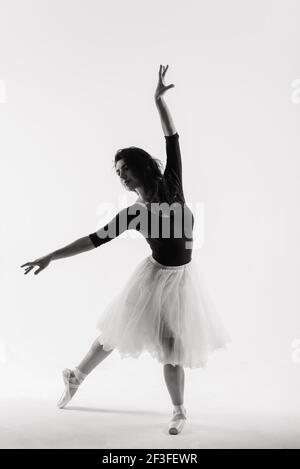 Flexible female, ballet dancer in black bodysuits, ballerina Stock Photo