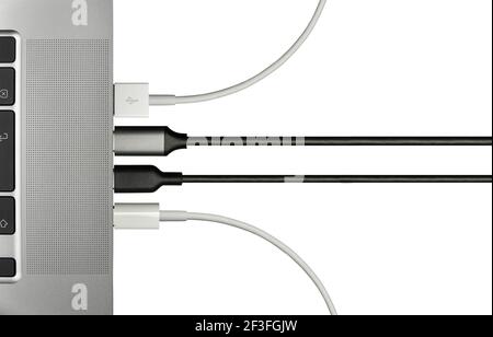 Various Cables Plugged In To A Laptop Computer For Various Peripheral Devices, Isolated On A White Background With Copy Space Stock Photo