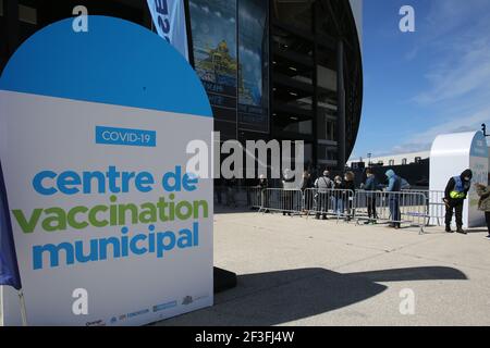 A sign reading 'Centre de Vaccination municipal' is seen next to people aged 50 to 74 wait to be vaccinated in the lounges of the football stadium in the city of Marseille. Stock Photo