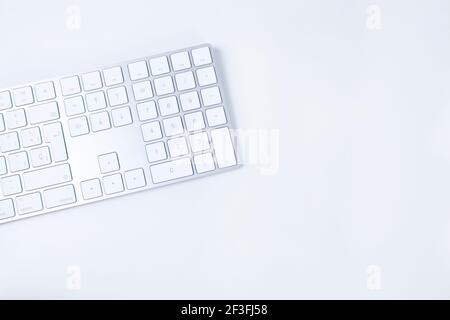 White and silver modern keyboard on white background. Concept of freelance, working from home, typing, translating. Copy space Stock Photo