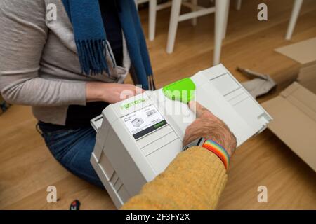 Man woman unboxing unpacking looking at the Festool Systainer Sys 3 TL Stock Photo