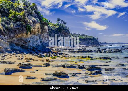 Amazing ocean coastline cliffs on beautiful summer day with white fluffy clouds Stock Photo
