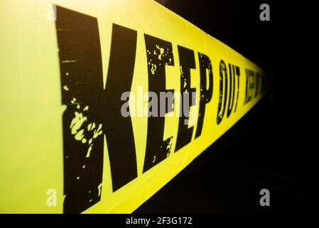 Close-up view of keep out tape against dark background Stock Photo