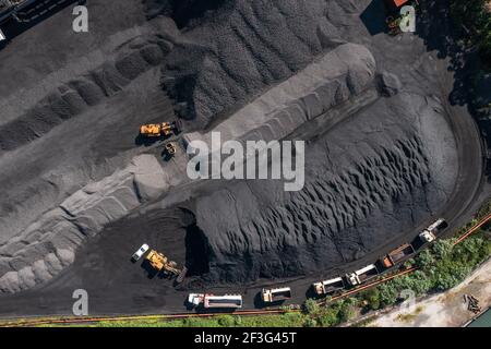 Top down aerial view of trucks lined up for loading coal at Port Kembla, NSW, Australia. Stock Photo