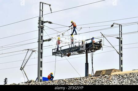 Beawar, India. 16th Mar, 2021. Workers test electric wires on the Delhi-Mumbai railway corridor, in Beawar. (Photo by Sumit Saraswat/Pacific Press) Credit: Pacific Press Media Production Corp./Alamy Live News Stock Photo