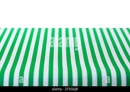 Table top covered with green and white stripped tablecloth Stock Photo