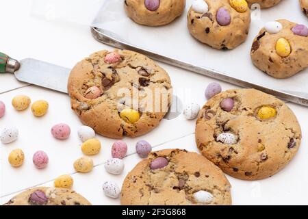 Homemade chocolate mini egg cookies and the raw cookie dough on a baking tray Stock Photo