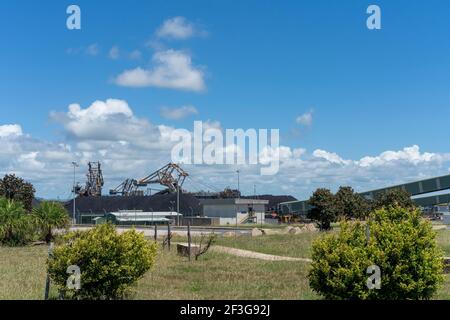Mackay, Queensland, Australia - March 2021: Huge machines working on coal stockpiles at Hay Point coal terminal Stock Photo