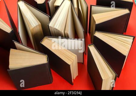 Composition with vintage old hardback books  on  red background. Books open. Back to school.  Education background. Stock Photo