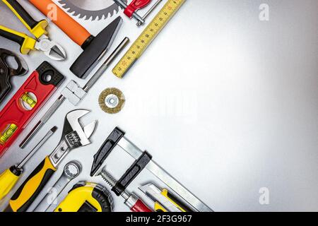 set of hand tools and working instruments on scratched metal textured background. top view Stock Photo