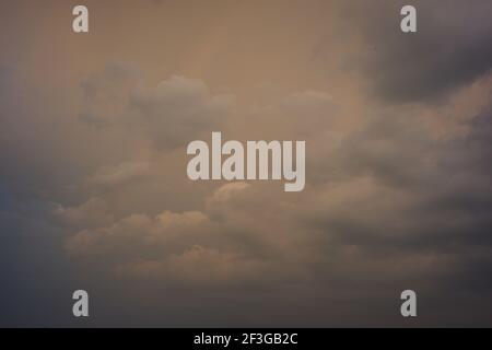 the sky was cloudy with gray and orange. atmosphere in the afternoon before it rains. the sky is dark during the rainy season Stock Photo