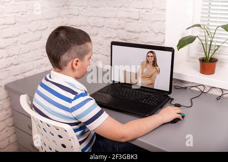 Child using laptop computer, studying through online e-learning system Stock Photo