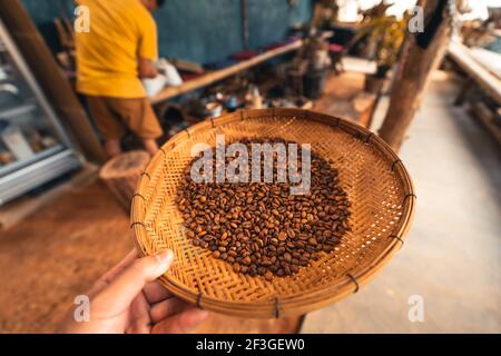 roasted coffee beans Coffee beans in a wooden tray Stock Photo