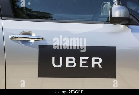 File photo dated 31/08/16 of the logo of Uber on a car door. Uber will give its UK drivers a minimum wage, paid holiday and an automatic pension plan from Wednesday, the firm said. Issue date: Wednesday March 17, 2021. Stock Photo
