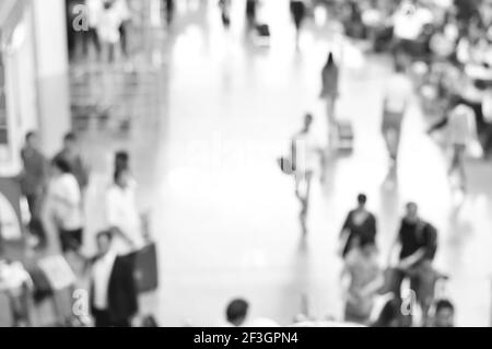Blurred people at the airport hallway in black and white, can be used as background Stock Photo