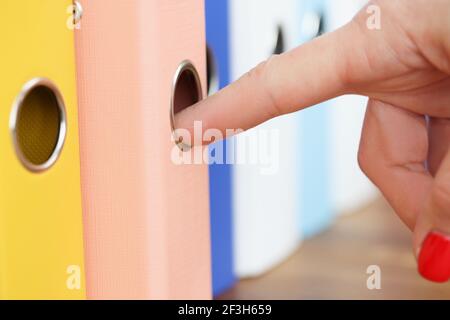 Woman's hand takes out folder with documents Stock Photo