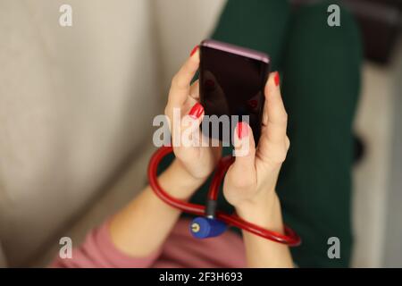 Female hands with lock hold smartphone closeup Stock Photo