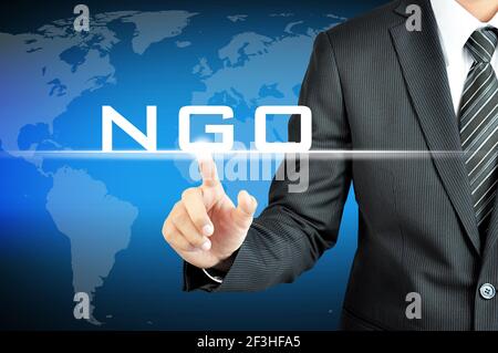 Businessman pointing on NGO (Non-Governmental Organization) sign on virtual screen Stock Photo