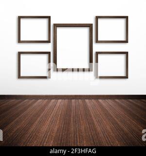 Wooden picture frames on white wall inside the room Stock Photo