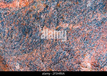 Spots and stripes are gray-red background. Textured red background. The texture of the sea stone is red-brown. Stock Photo