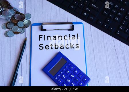 Text on blue clip board with calculator, pen, glass jar with coins and keyboard Stock Photo