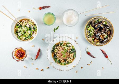 A top view of various healthy delicious food in bowls on a white surface Stock Photo