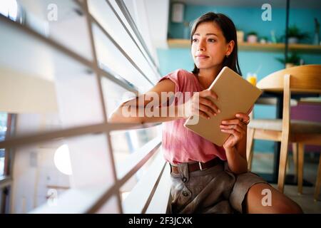 Portrait of cheerful woman using portable pc for blogging in social networks Stock Photo