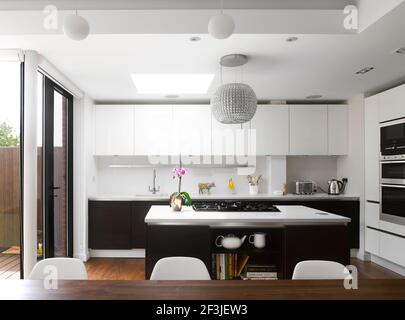 Modern kitchen with island unit and white fitted units Stock Photo