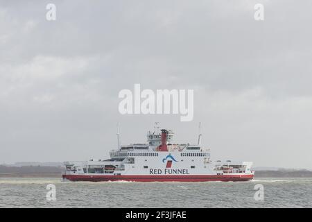 Southampton, UK, 11 Mar, 2021. Windy conditions provide a choppy crossing for one of the Red Funnel Isle of Wight ferries crossing the Solent. Southampton docks has recently been given free port status. Stock Photo