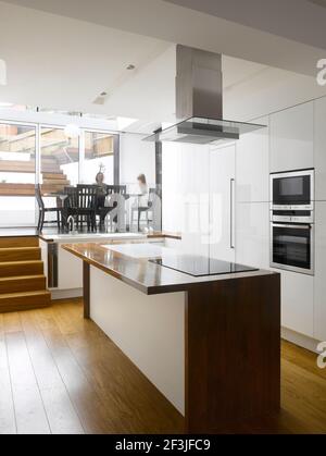 View across kitchen towards dining room and garden | Architect: Paul Archer Design | Stock Photo