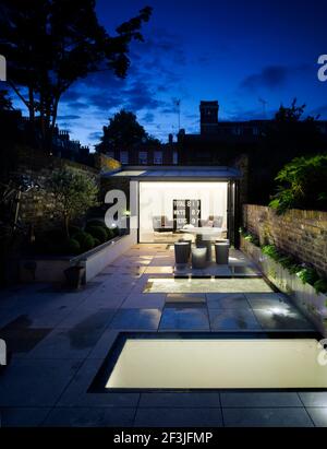 Night view of new basement level under garden and garden pavilion | Architect: Paul Archer Design | Stock Photo