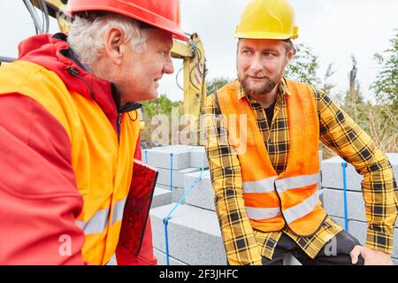 Construction workers and site managers in a meeting on the construction site of building a house Stock Photo