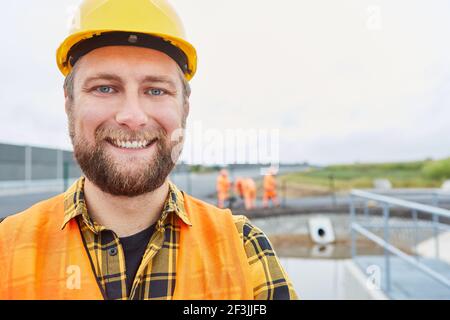 Smiling construction worker as a proud road builder on a construction site in the new development area Stock Photo