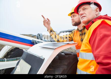The architect and foreman control the progress of road construction on the construction site Stock Photo