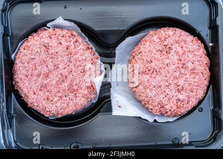 Vegetarian burger patties in plastic container. Stock Photo