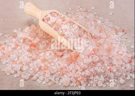 Pink himalayan salt. Close-up Himalayan Pink Rock Salt In wooden Spoon on black background. top view. High Angle View Of Himalayan Salt With Wooden Sp Stock Photo