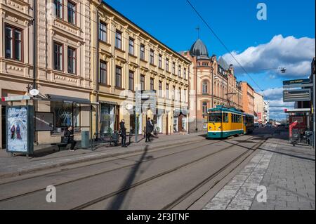 Tram on Tradgardsgatan in Norrkoping, Sweden. The yellow trams are iconic for Norrkoping. Stock Photo