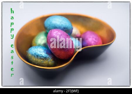 Easter chocolate eggs in the lacquer bowl with Happy Easter message Stock Photo