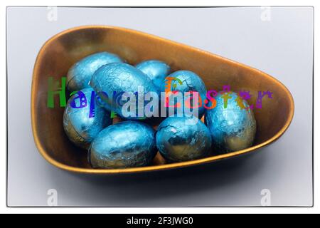 Easter chocolate eggs in the lacquer bowl with Happy Easter message Stock Photo