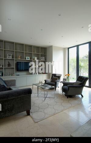 Seating around coffee table in modern living room Stock Photo