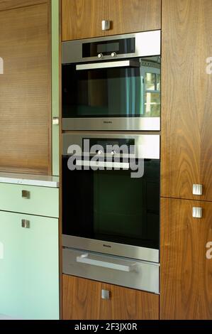 Contemporary Art Deco style walnut and mint Kitchen refurbishment Stock Photo