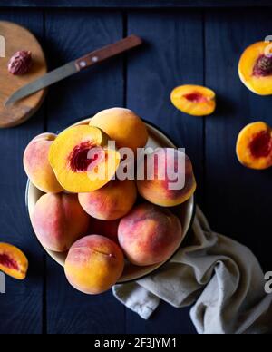 Fresh juicy Peaches on the wooden table in the kitchen at country home Stock Photo