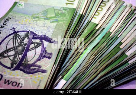 Bank of Korea 10 000 won paper money bills spread out background image, used korean won cash background image. Stock Photo