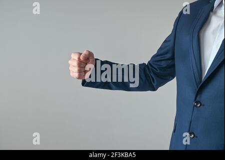 a man in a suit shows his fist. High quality photo Stock Photo