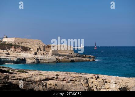 Maltese coastline with the view to Saint Elmo brealkwater and Saint Elmo lighthouse, view from Ricasoli fort Stock Photo