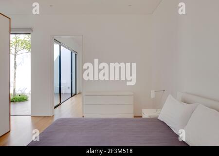 Bedroom in Mandai Courtyard House in Singapore. Stock Photo