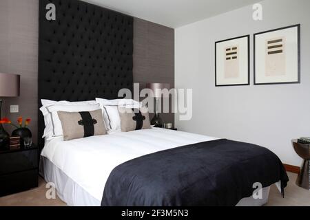 Guest bedroom with charcoal and beige colour scheme in UK show home Stock Photo